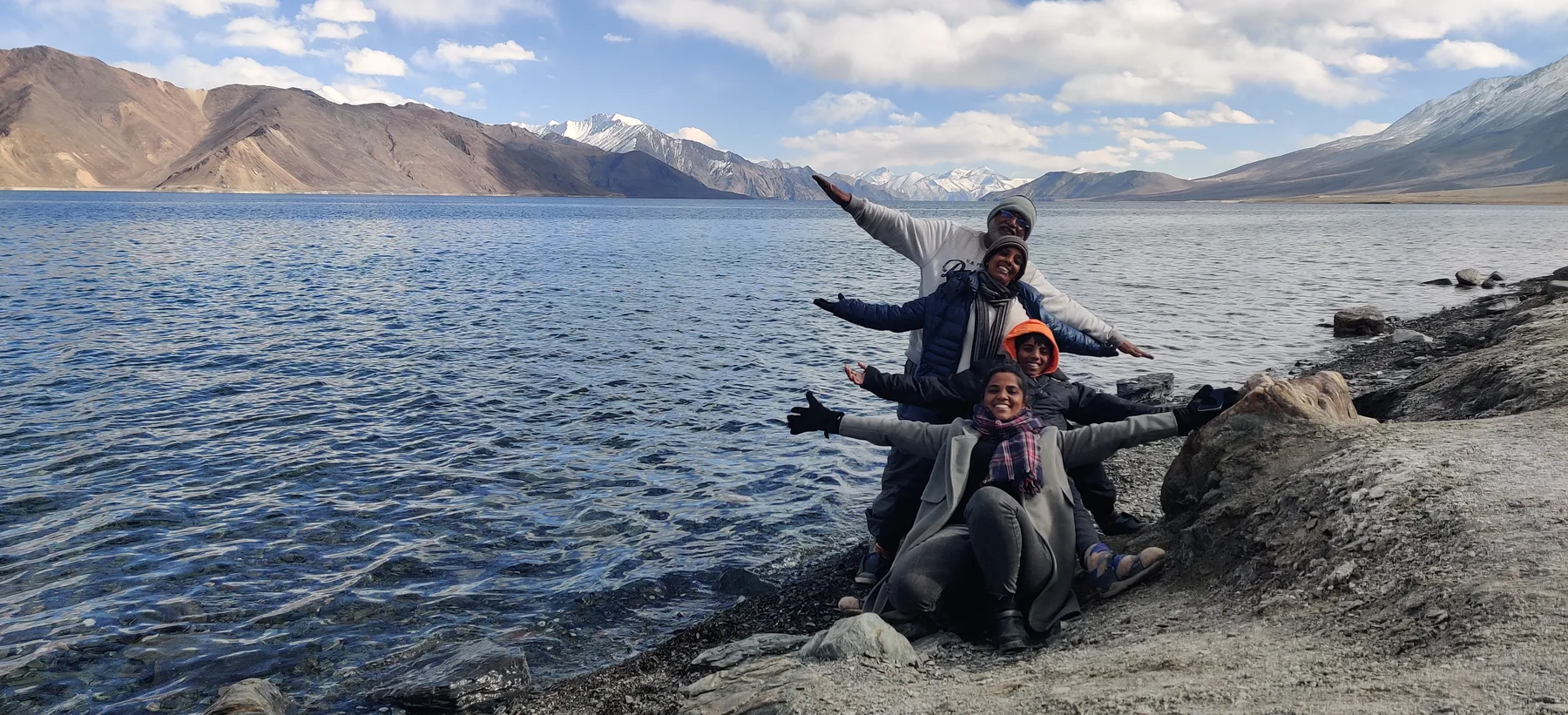 The still blue of Pangong Lake at dusk beneath bare mountains.