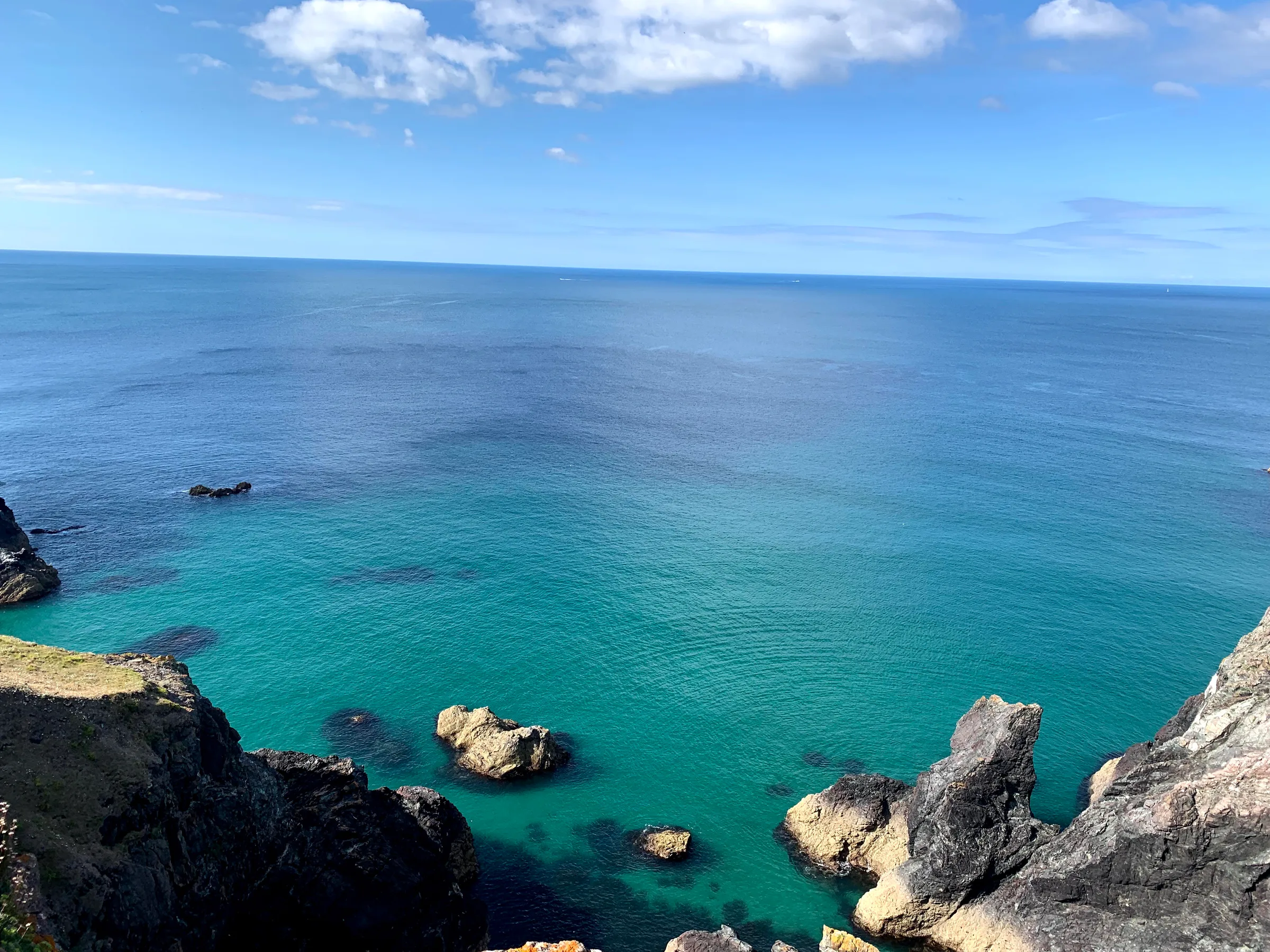 A turquoise cove ringed by dark rock.